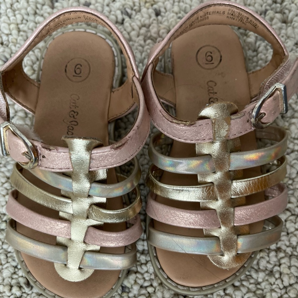 Used. Cat and Jack pink and gold sandals. Normal kids wear and tear.